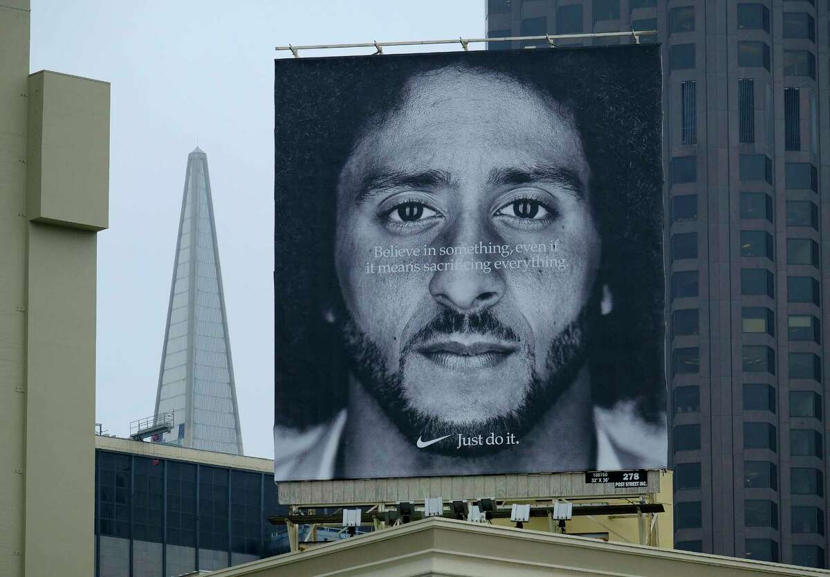 A large billboard stands on top of a Nike store showing former San Francisco 49ers quarterback Colin Kaepernick at Union Square, Wednesday, Sept. 5, 2018, in San Francisco. An endorsement deal between Nike and Colin Kaepernick prompted a flood of debate Tuesday as sports fans reacted to the apparel giant backing an athlete known mainly for starting a wave of protests among NFL players of police brutality, racial inequality and other social issues. (AP Photo/Eric Risberg)