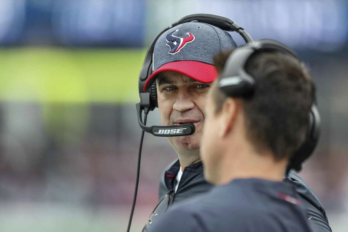 Houston Texans head coach Bill O'Brien talks to quarterbacks coach Sean Ryan during the first quarter of an NFL football game against the New England Patriots at Gillette Stadium on Sunday, Sept. 9, 2018, in Foxborough, Mass.