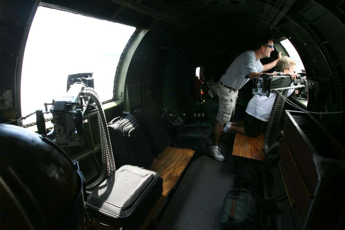 Zavk Zako, 11 of Norwalk, and his father, Matt, look out the machine gun window of the Liberty Belle B-17's press flight on Monday, July 12, 2010. Flights will be open to the public on July 18th. The press flight flew from Sikorsky Memorial Airport.