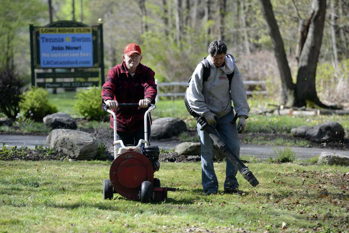 Camilo Eiomez and Fabio Velosquez help with the clean up efforts on April 30, 2016 at the Long Ridge Club in Stamford. The private swim and tennis clubwas preparing for its season opening on Sunday.
