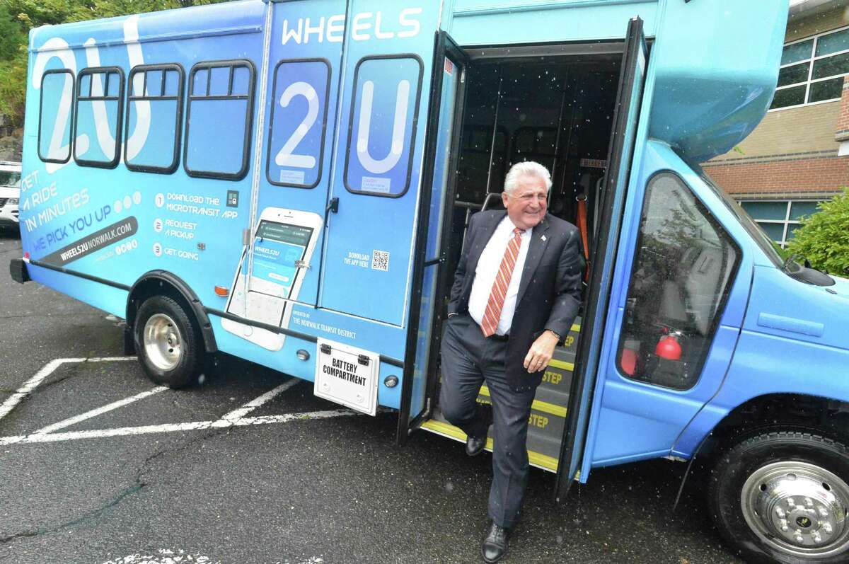 Norwalk Mayor Harry Rilling steps off one of the new graphic wrapped buses as the Norwalk Transit District introduces its new MicroTransit on demand buses Wheels2U. The buses were shown at the Norwalk Transit District headquarters on Monday September 10, 2018 in Norwalk Conn.