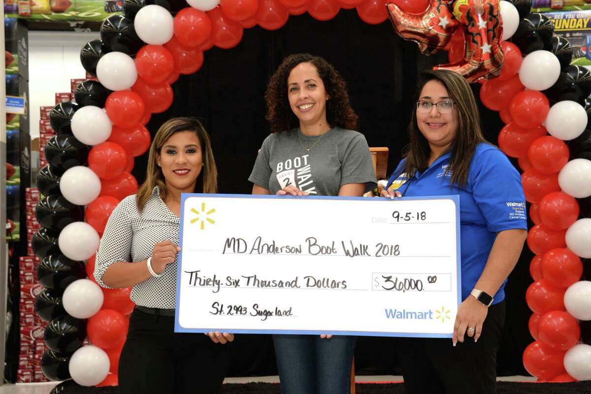 Walmart Store Manager Tonya Aguirre (Left), M.D. Anderson Representative Adelina Espat (Center) and Walmart Associate and Cancer Survivor Rebecca Romo pose with a check to celebrating the raising of $36,000 for MD Anderson Cancer Centers third annual Boot Walk to End Cancer at the Walmart Supercenter, 345 Highway 6, Sugar Land, on Sept. 5.