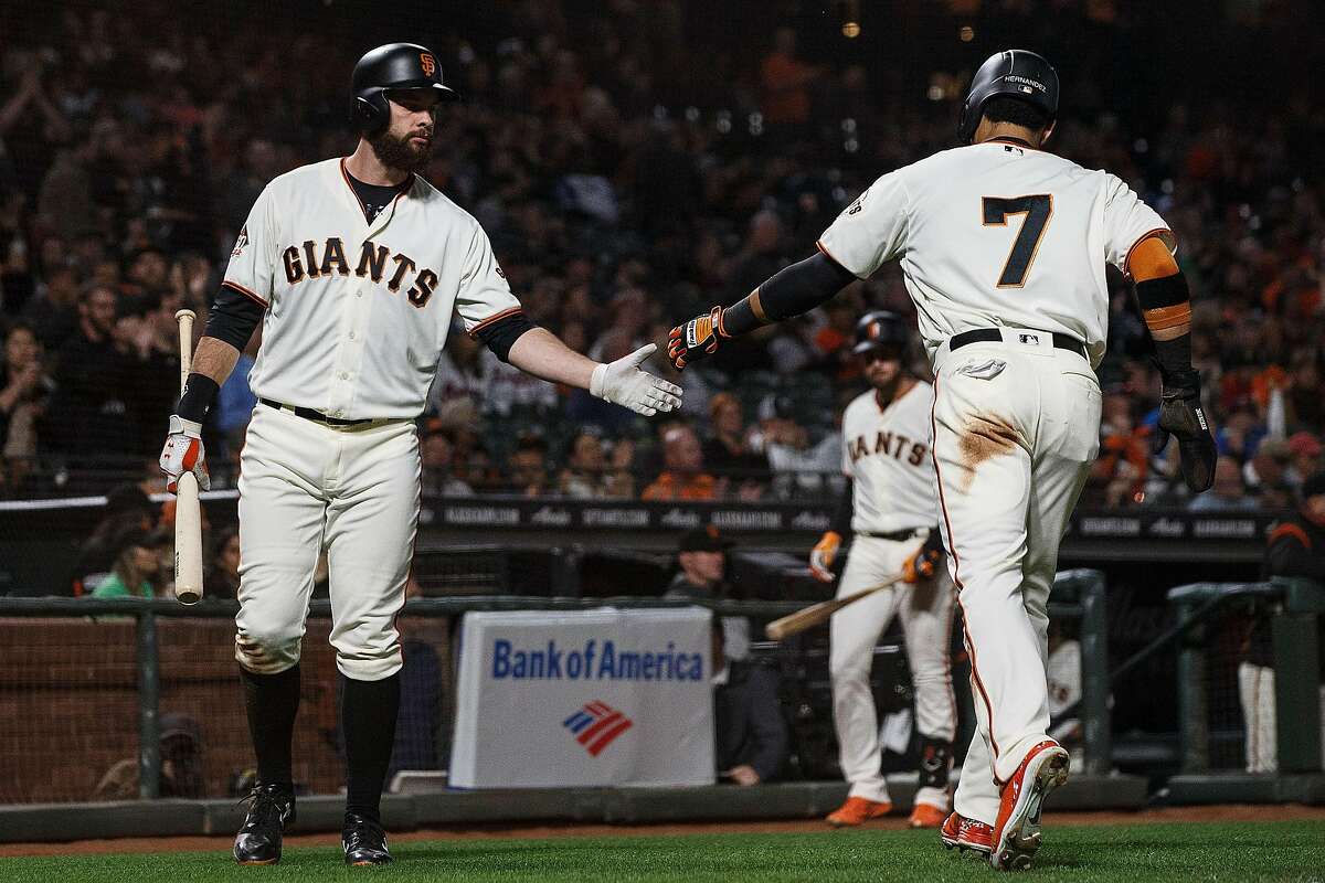 SAN FRANCISCO, CA - SEPTEMBER 10: Gorkys Hernandez #7 of the San Francisco Giants is congratulated by Brandon Belt #9 after scoring a run against the Atlanta Braves during the third inning at AT&T Park on September 10, 2018 in San Francisco, California. The Atlanta Braves defeated the San Francisco Giants 4-1. (Photo by Jason O. Watson/Getty Images)