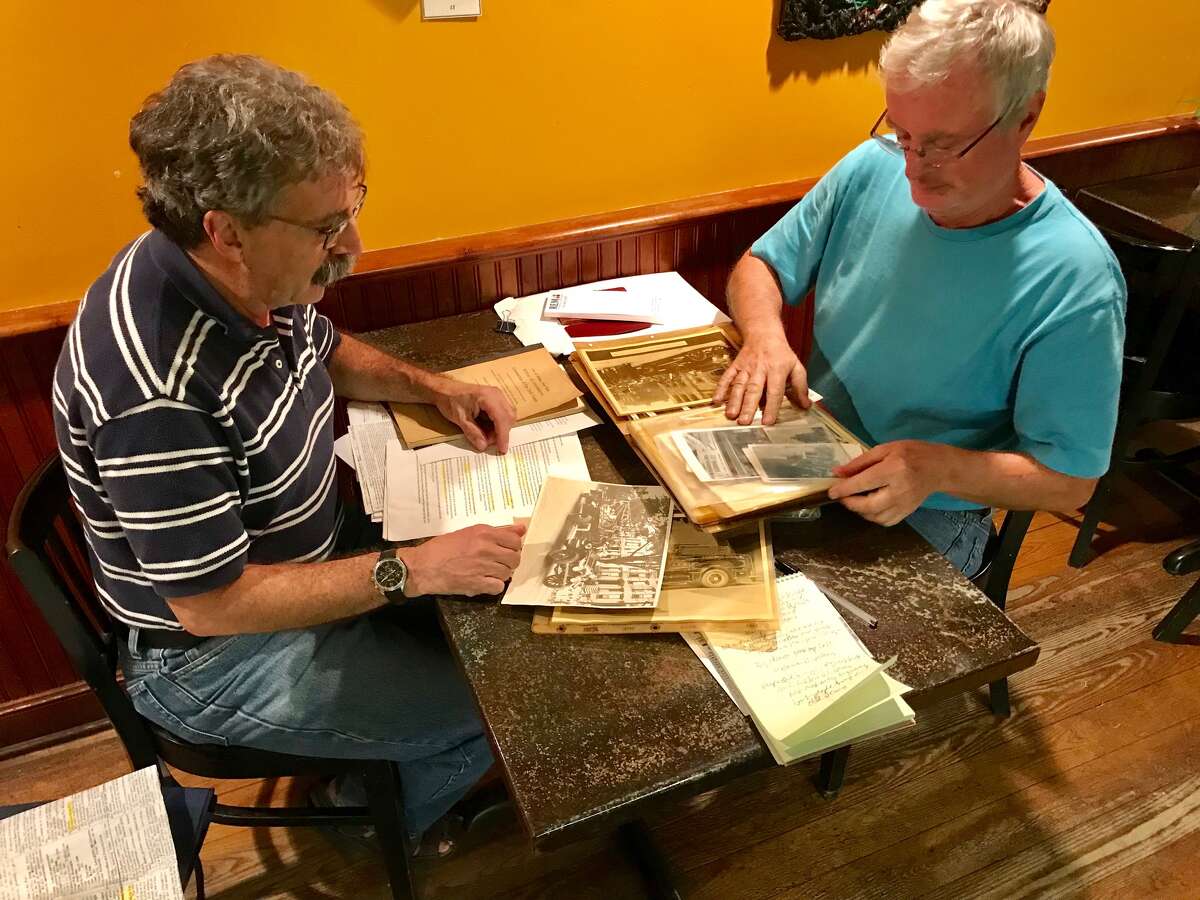 Albany city historian Tony Opalka, left, and Bill Tobler, a retired Albany Fire Department lieutenant, look over memorabilia that has been donated to the Albany Firefighters Museum.