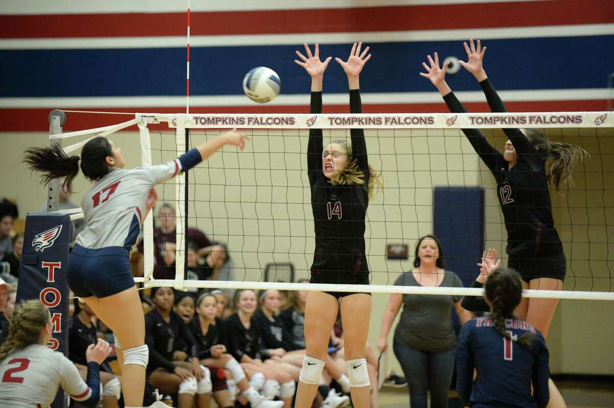 Allexandra Sczech (14) and Logan Lednicky (12) of George Ranch try to block a Tompkins kill shot in the first set of a high school volleyball match between the Tompkins Falcons and the George Ranch Longhorns on September 4, 2018 at Tompkins HS, Katy, TX.