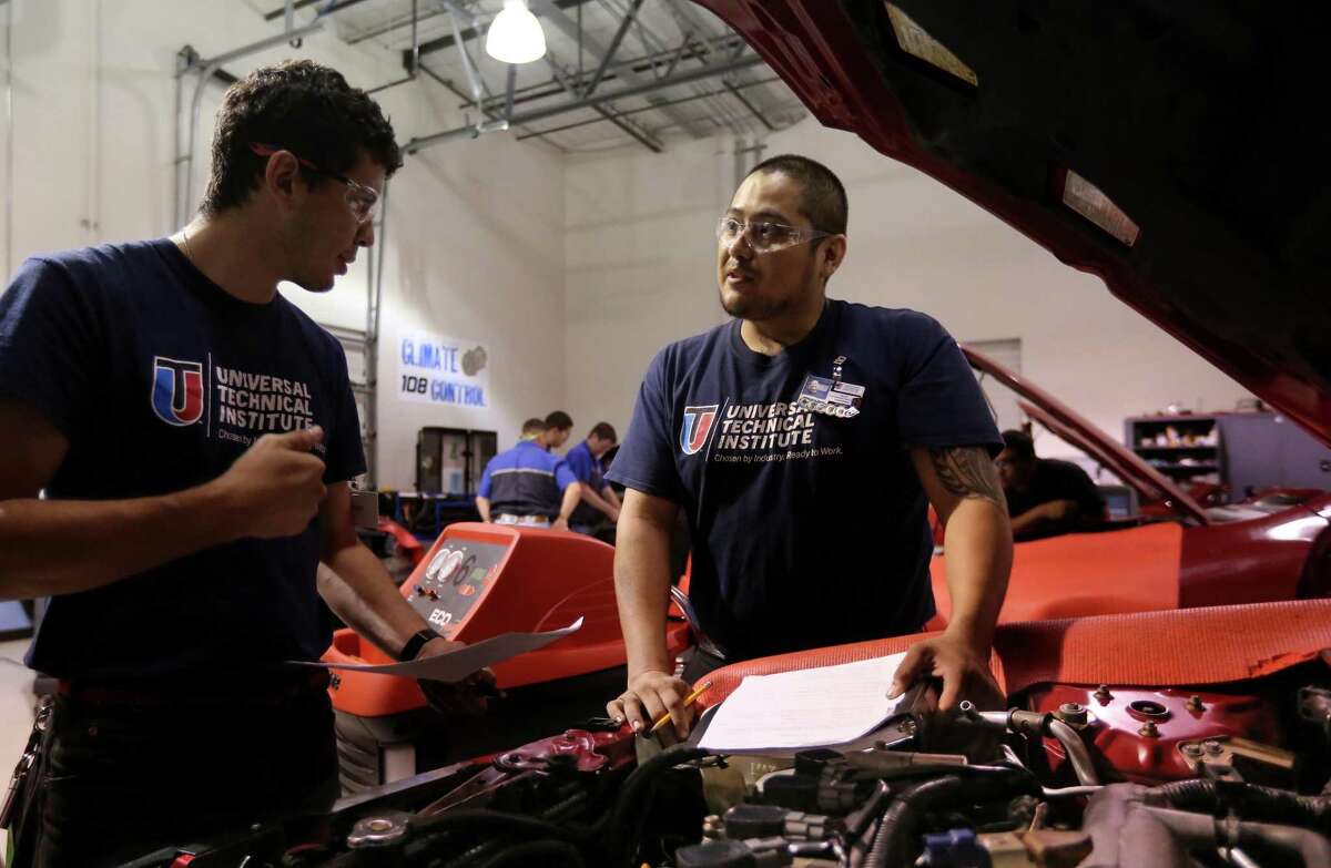 Students Marcos Escudero, left, and Oscar Hernandez discuss air conditioning knowledge at the Universal Technical Institute (UTI), technician training school for the transportation industry.