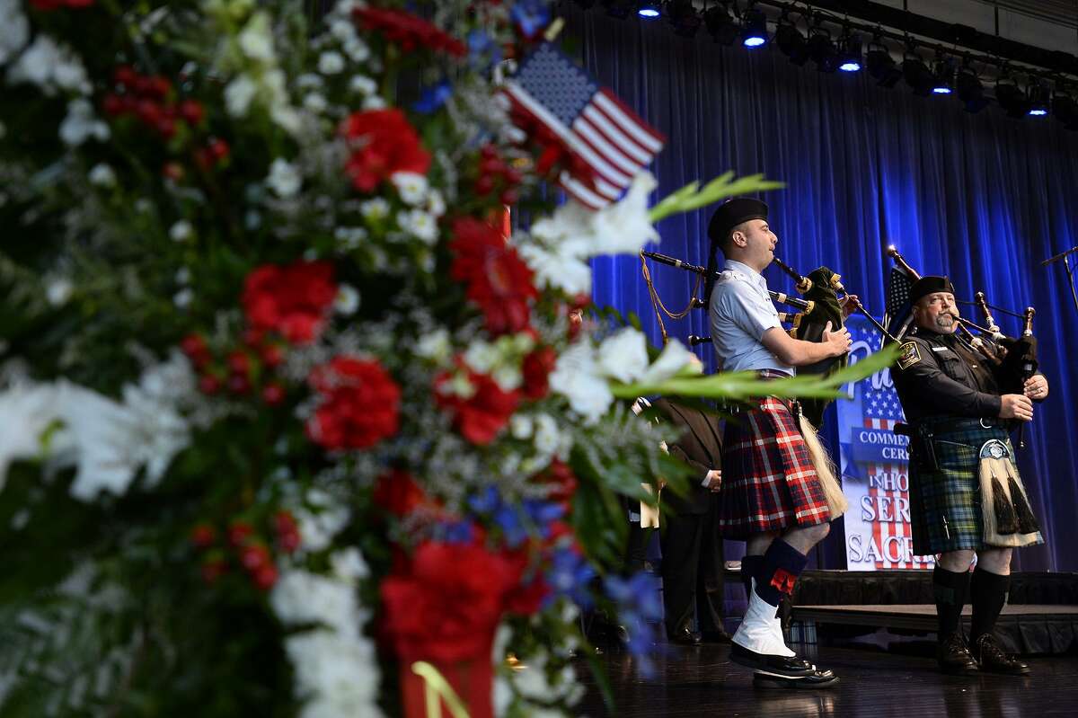 Coast Guard Petty Officer Brian Shajari and Vidor Police Officer Jeff Courts play "Amazing Grace" on the bagpipes during a memorial event at The Event Centre to the Sept. 11, 2001 terror attacks on Tuesday. Photo taken Tuesday 9/11/18 Ryan Pelham/The Enterprise