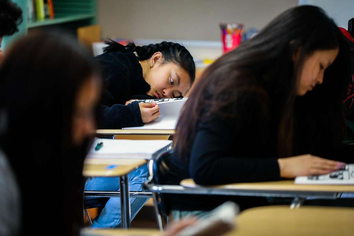 Makisha Brogan (center) puts her head on her desk� during a class at Phillip and Sala Burton High School in San Francisco, California, on Monday, Sept. 10, 2018. Gov. Gavin Newsom has a decision to sign or veto a bill that would require later start times for middle and high school students.