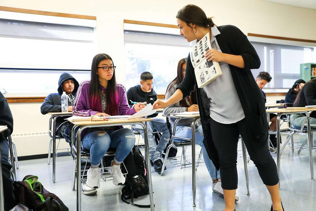 Jana Cam, 17, (left) chats with teacher Liz Kaufman during a literature class at Phillip and Sala Burton High School in San Francisco, California, on Monday, Sept. 10, 2018.