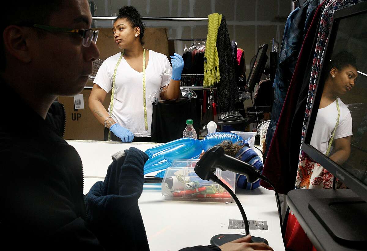 Itemizers Novia Chudha (middle) and Kevin Macandili (left, front) categorize clothing at the ThredUP warehouse in San Leandro, Calif., on Friday, February 6, 2015.