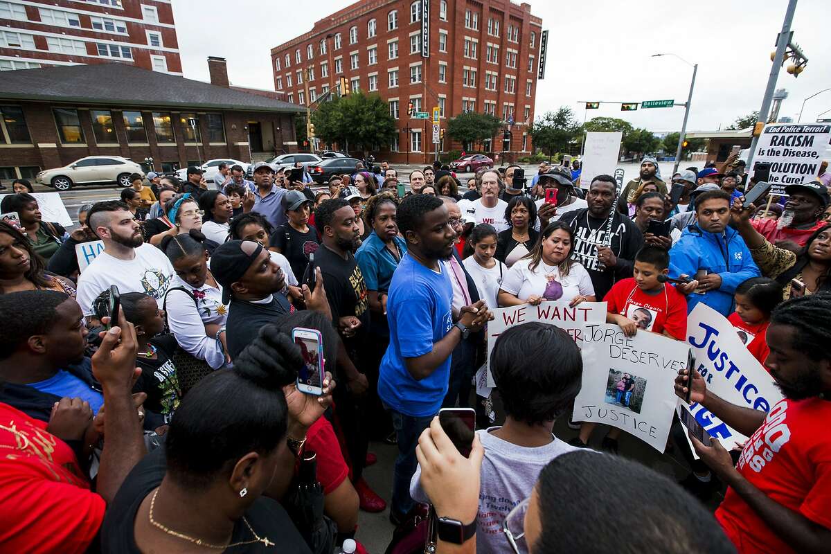 Protesters in the shooting death of Botham Jean, gather at the Jack Evans Police Headquarters, Monday, Sept. 10, 2018 in Dallas. Jean was shot Thursday by off-duty Dallas police officer Amber Guyger, who says she mistook his apartment for hers. (Shaban Athuman /The Dallas Morning News via AP)