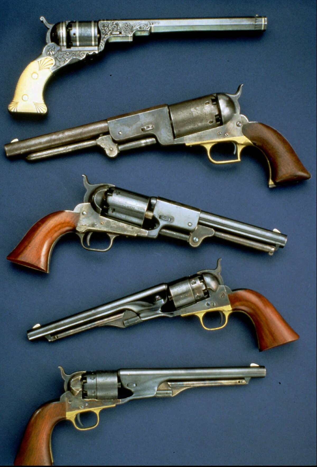 FILE-- Colt handguns are shown in this undated handout photo. Colt's Manufacturing Co., inventor of the six-shooter, plans to stop taking orders for most of its retail handguns so it can limit its liability in lawsuits, according to published reports, Monday, Oct. 11, 1999. The company plans focus instead on selling to the military, law enforcement agencies and collectors, who already account for the bulk of its business. (AP Photo/File)