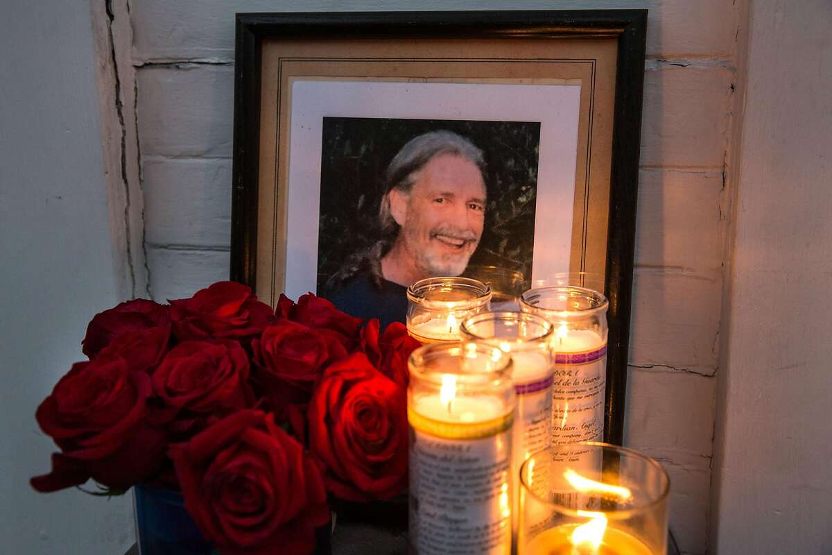 Framed photograph of Brian Egg surrounded by candles and roses placed outside of his house where family and friends gathered for a candle vigil in his honor on his birthday. He would have been 66 years old today. Tuesday, September 11, 2018 in San Francisco Calif.