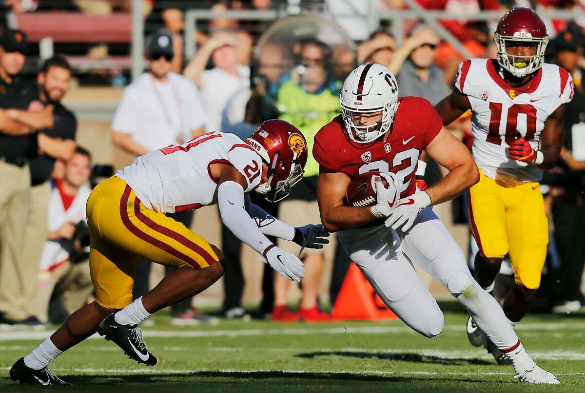 Stanford Cardinal tight end Kaden Smith (82) is tackled by USC Trojans safety Isaiah Pola-Mao (21) during the first quarter of an NCAA football game between Stanford Cardinal and USC Trojans at Stanford Stadium, Saturday, Sept. 8, 2018, in Stanford, Calif.