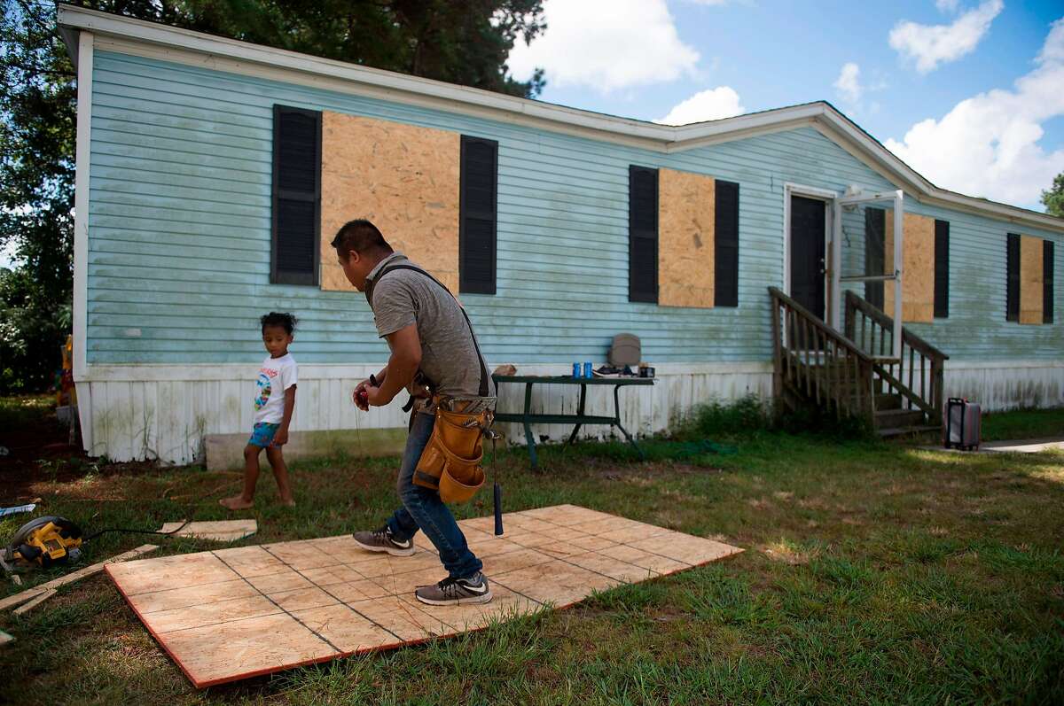 Eduardo Corta cuts plywood boards to put on his mobile home a day before the arrival of Hurricane Florence in Wilmington, North Carolina on September 12, 2018. - People fleeing North and South Carolina clogged coastal highways early Wednesday as Hurricane Florence, a monster Category 4 storm, bore down on the US east coast for a direct hit in a low-lying region dense with beachfront vacation homes.President Donald Trump, warning residents to get out of the way, said the federal government was "ready for the big one that is coming." (Photo by ANDREW CABALLERO-REYNOLDS / AFP)ANDREW CABALLERO-REYNOLDS/AFP/Getty Images