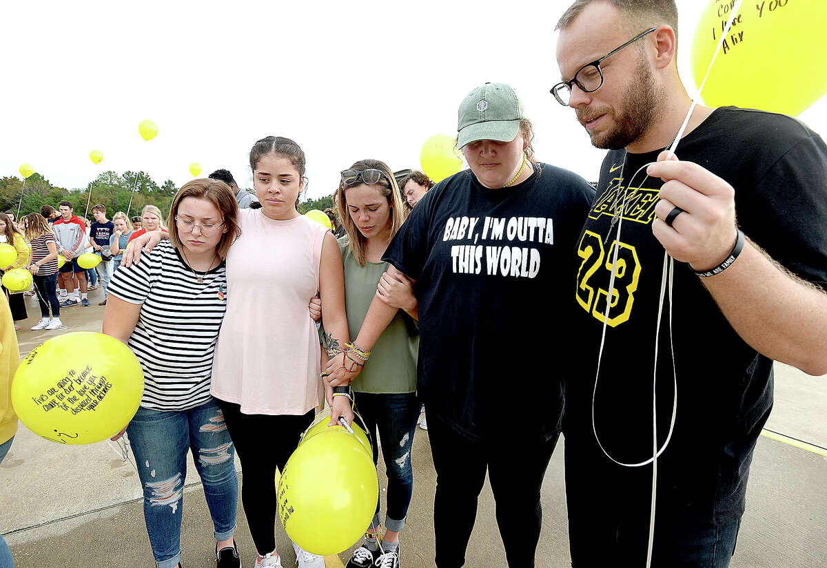From left, Katelynn Butler, Abigail Hecht, Hart Tomlinson, Moriah Miller, and Jimmy Banks join hands as they gather with others for a final prayer during a memorial balloon release at Praise Church in honor of the three teens killed in a car accident Sunday in Hardin County. 2018 Hardin-Jefferson graduate Alix Neel, and 2018 West Hardin graduates Garrett Saulters and Caringtin Mosley were remembered by friends, family and members of the community at the vigil. Visitations and funerals for the teens began Wednesday and continue through Friday. Wednesday, September 12, 2018 Kim Brent/The Enterprise