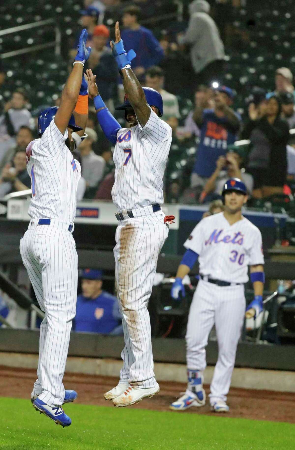 New York Mets' Jose Reyes, left, catches Philadelphia Phillies