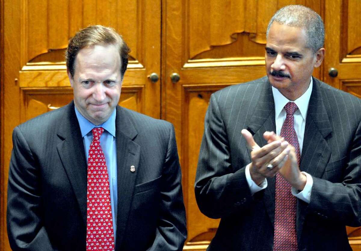 U.S. Attorney General Eric Holder applauds during the investiture of David B. Fein, left, as U.S. Attorney for Connecticut at the Yale Law School in New Haven, Conn. on Monday July 12, 2010. (AP Photo/The Register, Arnold Gold)