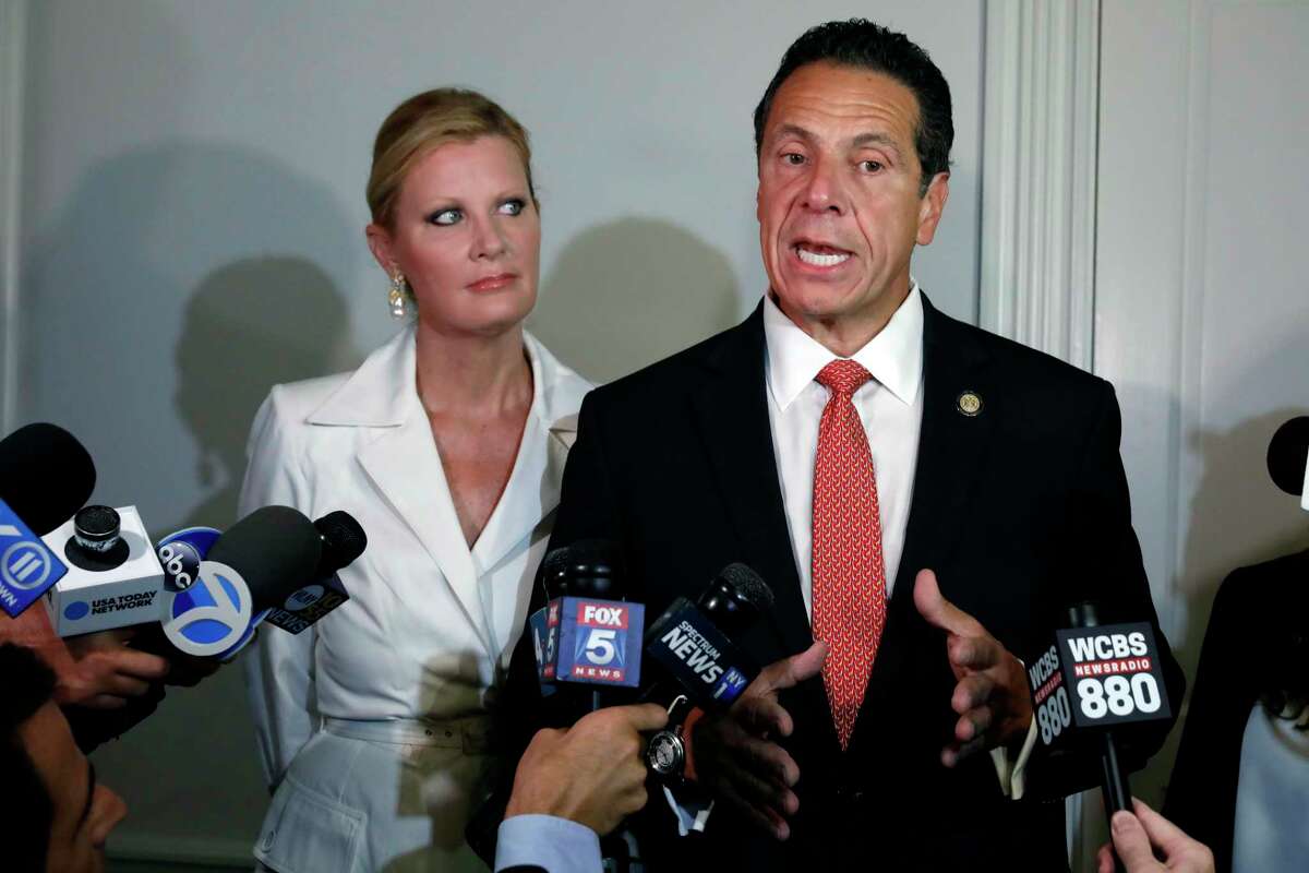 New York Gov. Andrew Cuomo is accompanied by his girlfriend Sandra Lee as he talks to the press after casting his primary election ballot, at the Presbyterian Church of Mount Kisco, in Mount Kisco, N.Y., Thursday, Sept. 13, 2018.