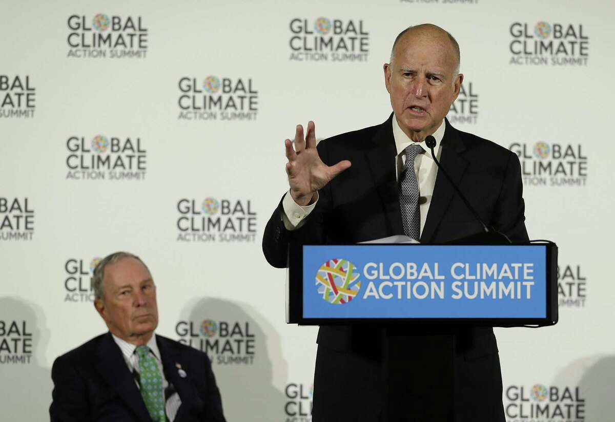 California Gov. Jerry Brown speaks as Michael Bloomberg, left, listens during a news conference at the Global Action Climate Summit Thursday, Sept. 13, 2018, in San Francisco. Gov. Brown started his global climate summit by saying that President Donald Trump will likely be remembered as a liar and fool when it comes to the environment. The Democratic Brown and former New York City Mayor Michael Bloomberg held a press conference Thursday on the first full day of the summit that is partly a rebuke of the Trump administration.