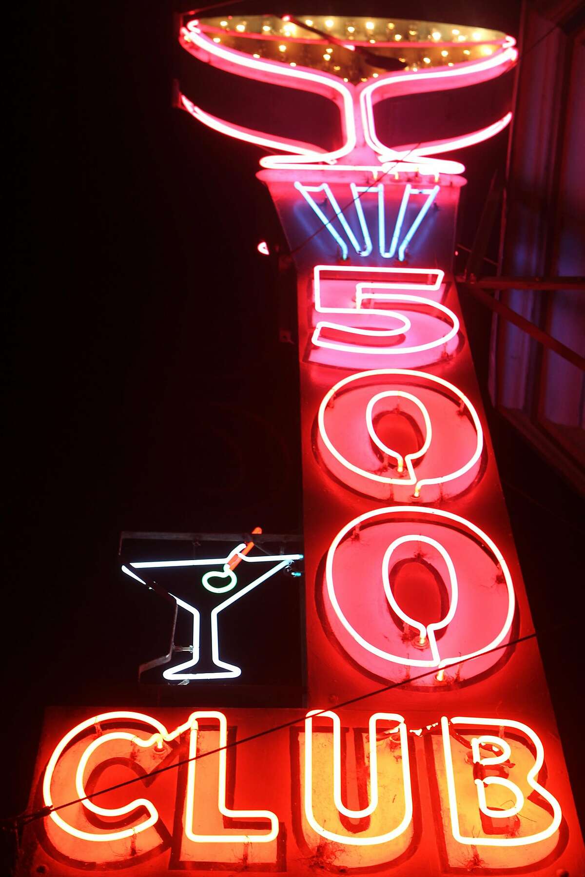 The big martini glass and the tall 500 Club sign attracts people passing by in the mission in San Francisco, Calif., on Thursday December 4, 2014.
