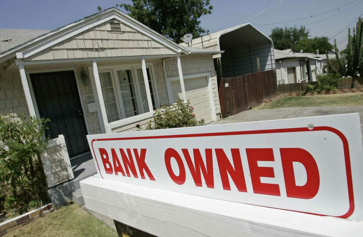 This Aug. 14, 2007, file photo shows a sign of a house under foreclosure in Antioch, Calif. As home values plummeted after the housing bubble burst in 2007, many borrowers with exotic types of loans were stuck, unable to refinance as lenders began to tighten their lending criteria. That set the stage for cascading mortgage defaults.