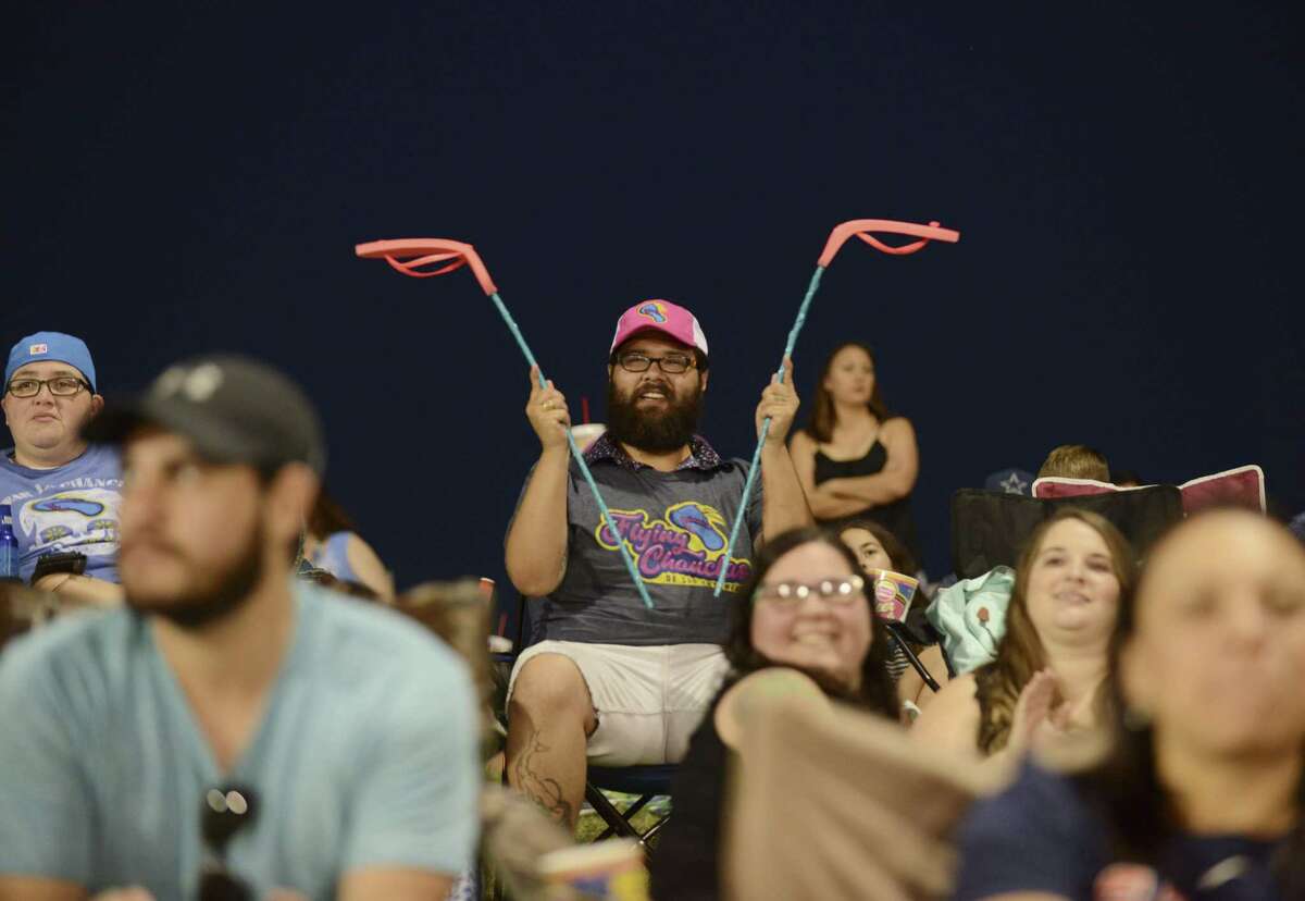 John Gonzalez, a fan of the Flying Chanclas de San Antonio, cheers using his homemade chanclas on a stick as Flying Chanclas play the Corpus Christi Hooks at Wolff Stadium on Saturday, May 5, 2018. The "flying chancla" is the mythical thrown sandal, said to be a form of discipline doled out by Latino mothers and grandmothers.