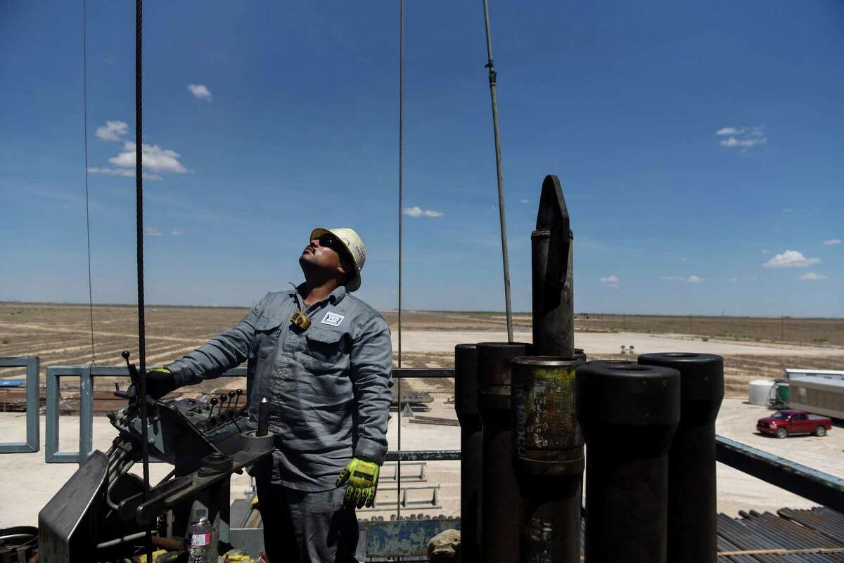 A contractor maneuvers drilling pipe at a Colgate Energy LLC oil rig in Reeves County. After the oil bust, oil and gas companies cut the costs of prodcution, but analysts wonder if those savings have topped out. Spending on water management in the Permian Basin, for example, is likely to nearly double to more than $22 billion in just five years, according to industry consultant IHS Markit.
