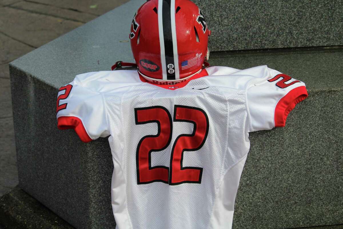 New Canaan is honoring the late Jason Cooper with his No. 22 jersey and a "Coop" sticker on the back of its helmets.