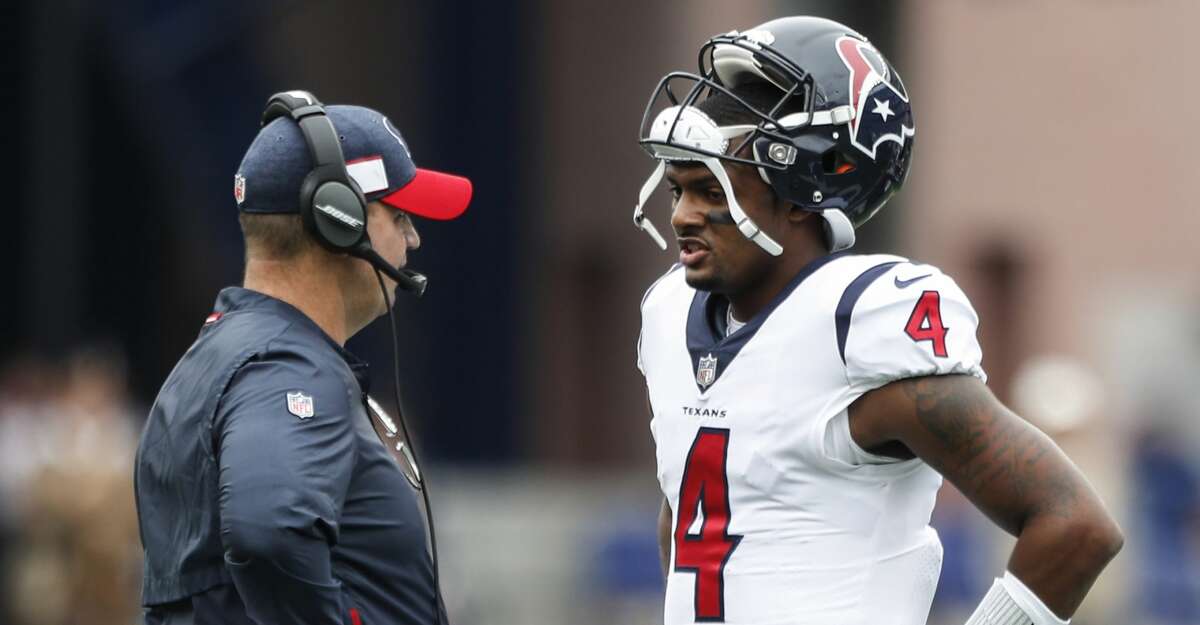 Houston Texans head coach Bill O'Brien talks to quarterback Deshaun Watson (4) during a time out in the first quarter of an NFL football game against the New England Patriots at Gillette Stadium on Sunday, Sept. 9, 2018, in Foxborough, Mass.