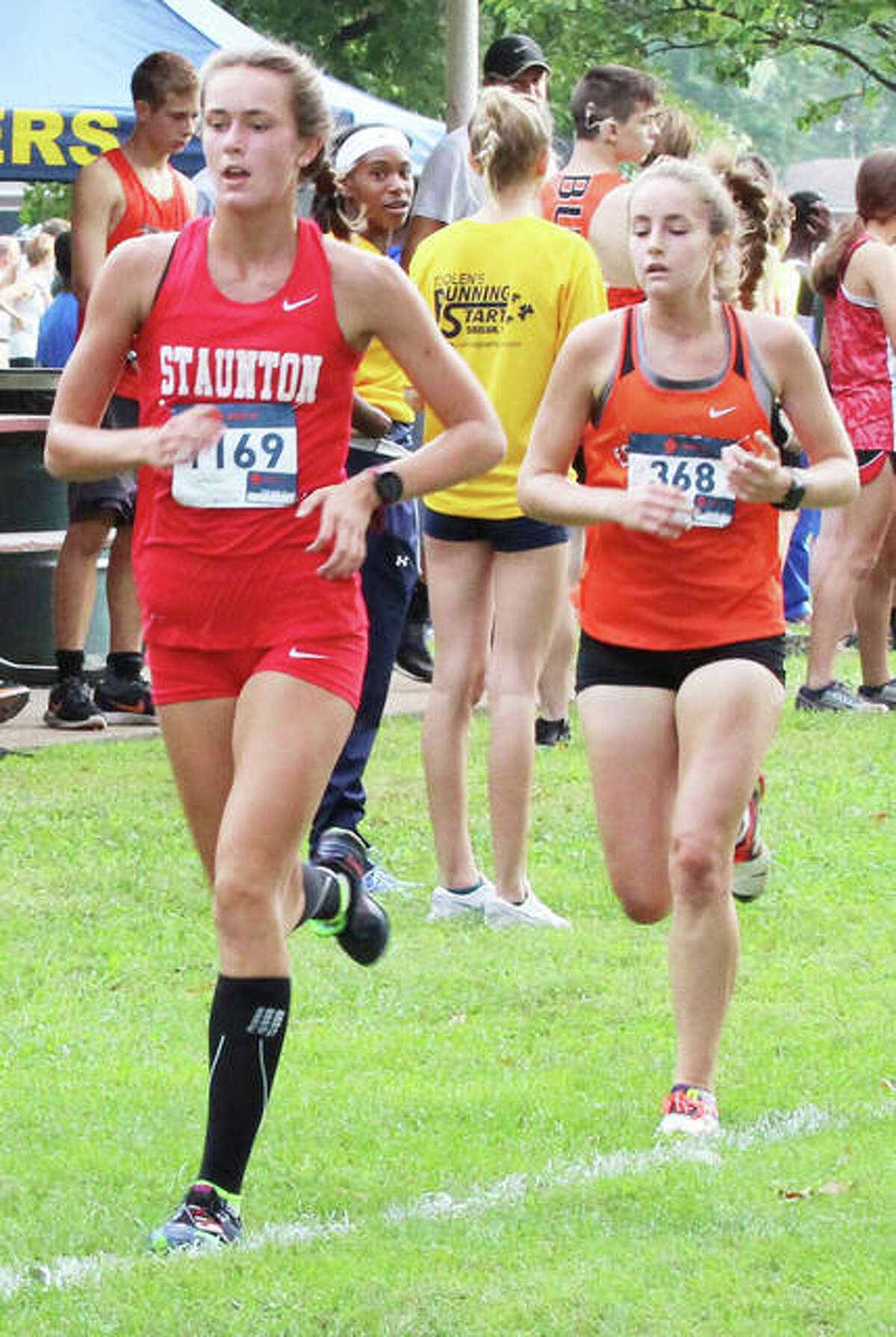 Staunton sophomore Lydia Roller (left) and Edwardsville senior Hannah Stuart run third and fourth midway through the Granite City Invite on Sept. 1.