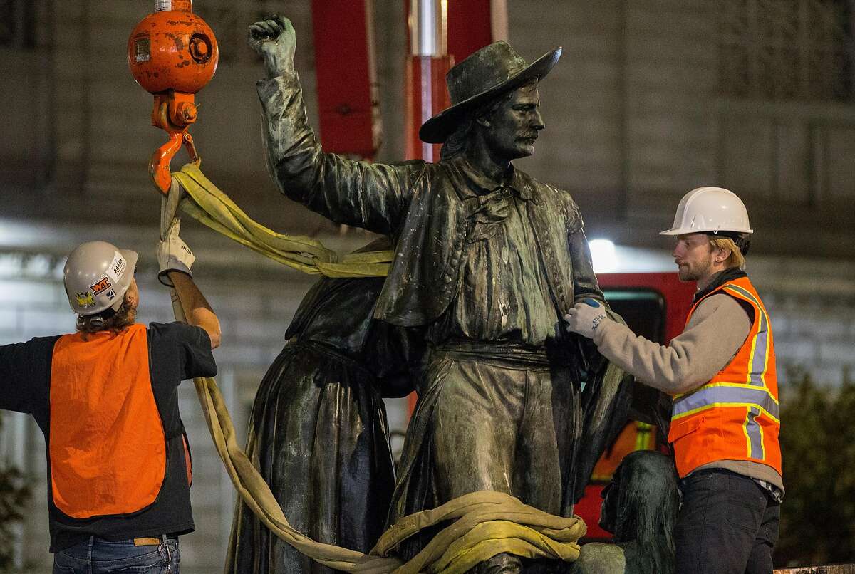 Workers place the controversial 'Early Days' statue, one of five statues that make up the Pioneer Monument, on a truck after being removed from Civic Center Plaza in San Francisco Calif. Friday, Sept. 14, 2018.