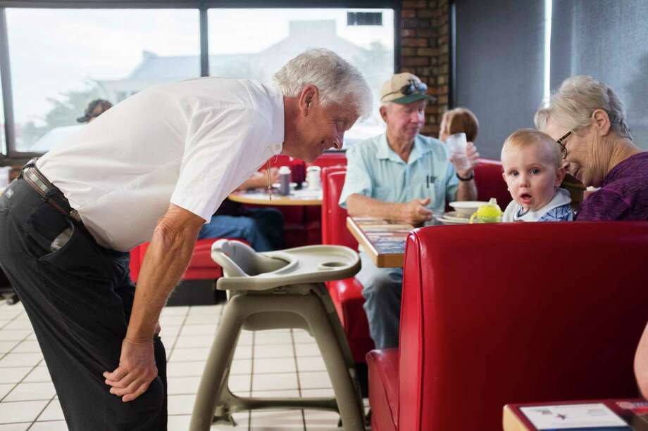 Brent McKee, owner of McKee's 24 Hour Family Restaurant, greets a baby during breakfast, Friday, Sept. 7, 2018, in Paris. Photo: Marie D. De Jesús, Staff Photographer / © 2018 Houston Chronicle