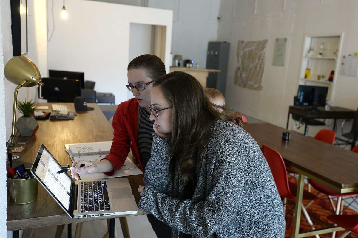 A man and woman share a co-working space. Employment trends show a greater number of people are unable to find full-time employment and rely on freelance work to get by, according to the Middlesex County United Way.