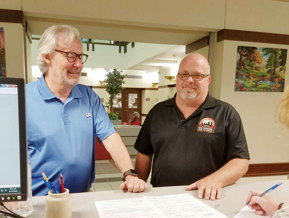 Madison County Democratic Party Chairman Mark Von Nida, left, with Chris Hankins as he filed his paperwork Friday morning at Madison County Clerk’s Office.