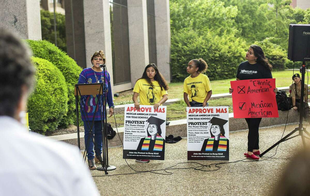 Professor Angela Valenzuela of Department of Educational Leadership and Policy speaks to protesters as Karen Acua, 13, and Modesta Bocanegra, 13, both seventh-graders at KIPP Camino Academy, and their Mexican-American studies teacher Lucero Saldaa hold signs as they join a June protest and rally before the Texas State Board of Education meeting on what to teach in a newly approved name of "ethnic studies course."