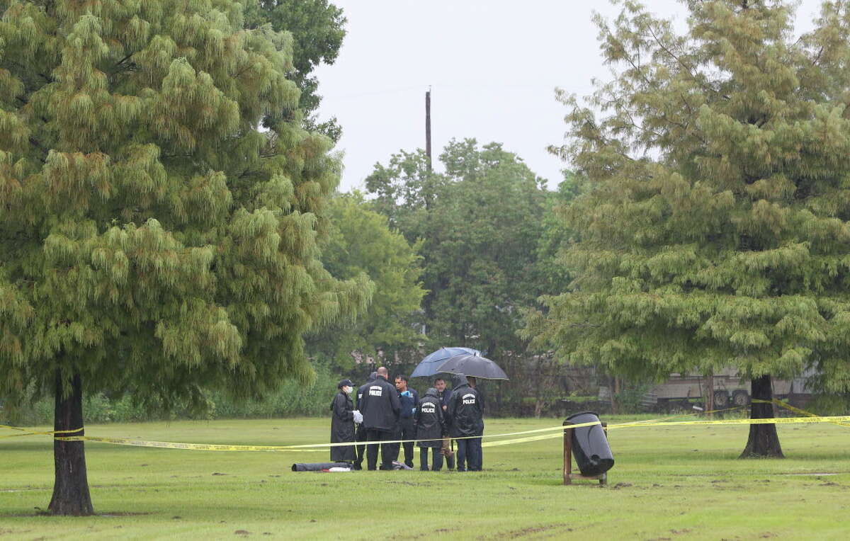 HPD authorities investigate a scene where a male body was found with gunshot wounds at Beverly Hills Park on Friday, Sept. 14, 2018, in Houston. The deceased was about 25 years old Hispanic with many tattoos. The deceased was shot multiple times at torso and head.