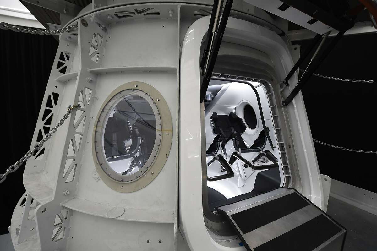(FILES) In this file photo taken on August 13, 2018 the SpaceX Crew Dragon simulator used to train NASA astronauts who will travel to the International Space Station aboard Crew Dragon, is show to the media during a press tour at SpaceX headquarters in Hawthorne, California. - SpaceX on Thursday, September 13, 2018, announced a new plan to send a tourist around the Moon on its Big Falcon Rocket (BFR), a massive launch vehicle that is being designed to carry people to deep space. "SpaceX has signed the world's first private passenger to fly around the Moon aboard our BFR launch vehicle -- an important step toward enabling access for everyday people who dream of traveling to space," the company said on Twitter. (Photo by Robyn Beck / AFP)ROBYN BECK/AFP/Getty Images