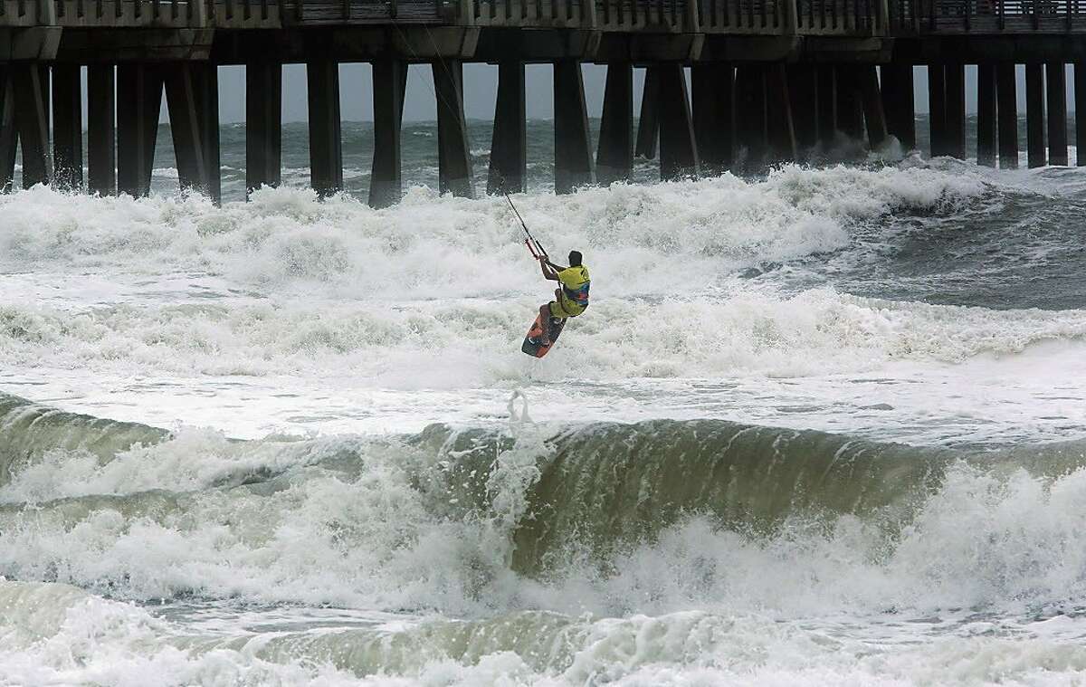 Kite Boarder Dimitri Maramenides heads out next to Jennette's Pier in Nags Head, N.C., as Hurricane Florence makes landfall further south on Friday, Sept, 14, 2018.