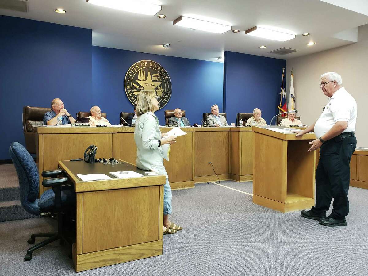 Humble Assistant Fire Chief Mike Legoudes (right) explains to Humble resident Arliss Bentley (left) why the fire department is requesting 6 new firefighters at the Humble Budget Adoption Meeting on September 13, 3018.