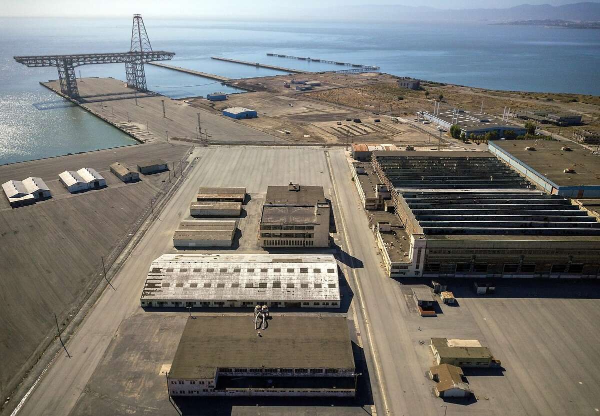 Aerial photos of Hunters Point Naval Shipyard showing Buildings 366 (white on left, middle) 351, above that on the right, and 411 (middle on the right) in Parcel G in San Francisco, Calif., on Tuesday, September 11, 2018. The Navy's retesting plan for Parcel G is being brought into question. When the U.S. Navy pledged to perform new soil tests at its Superfund waste site in San Francisco, the priority was "to protect the human health and the environment." But the Navy's re-testing plan is largely based on a cost-cutting report it paid a defense contractor to put together more than six years ago. What's more, the old report relies on data collected by Tetra Tech, the cleanup firm that submitted fake measurements and got caught. It essentially advocates for lowering cleanup standards and leaving more radioactivity in the ground. Multiple government agencies have now come out against the Navy?s plan to re-test Parcel G, saying that it could put public health at risk if it is not changed. Environmental experts agree and say even if the Navy listens to those agencies the plan is flawed and falls far short of what was promised in the wake of the Tetra Tech fraud revelations.