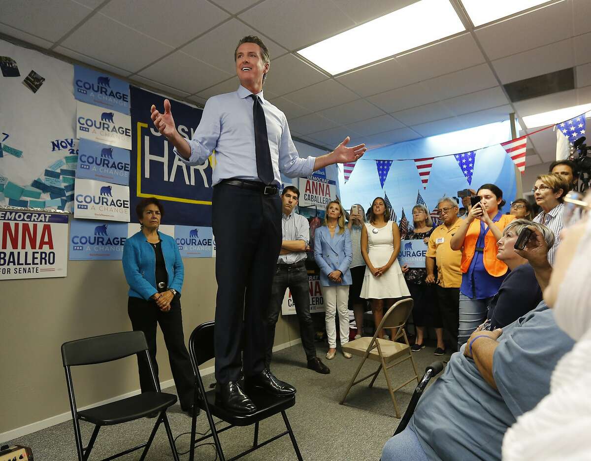 California gubernatorial candidate. Lt. Gov. Gavin Newsom, a Democrat, stands on a chair as he addresses supporters, during a stop Wednesday, Sept. 12, 2018, in Modesto, Calif. Newsom, who is battling Republican John Cox, is traveling the state to lend his support to Democrats running in contested districts. (AP Photo/Rich Pedroncelli)
