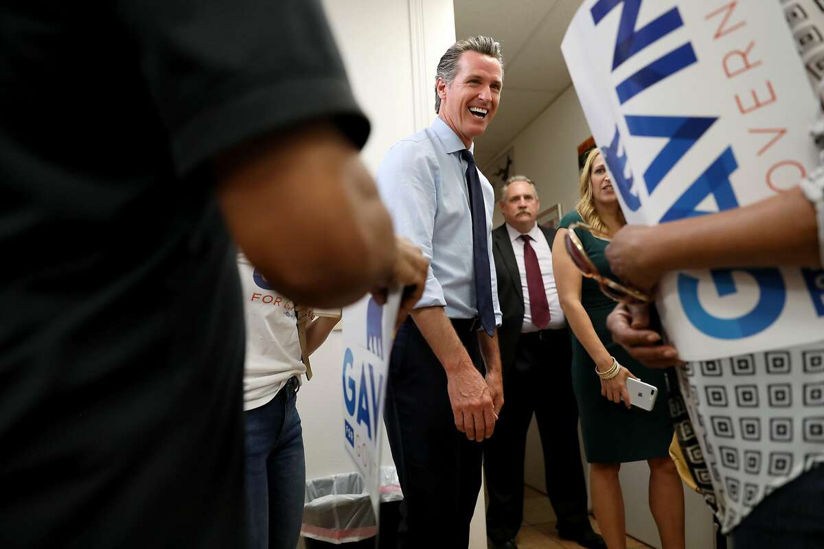 Democrat gubernatorial candidate Gavin Newsom shares a laugh with a supporter at the Fresno Democratic Campaign Headquarters in Fresno, Calif. on Wednesday, September 12, 2018. Newsom campaigned with TJ Cox, a US House candidate, CA-21, and Melissa Hurtado, a candidate for State Senate, SD-14.