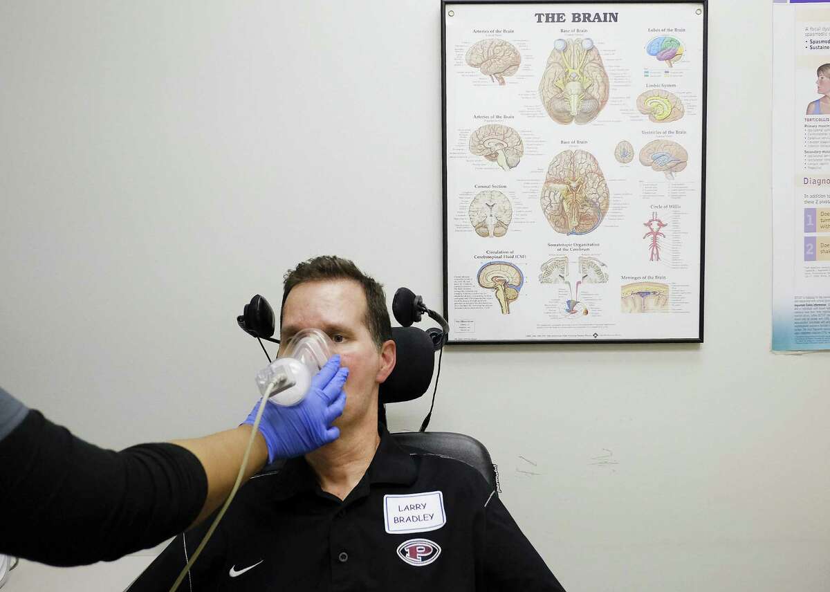 Respiratory therapist Elizabeth Robinson checks the oxygen and lung capacity of Larry Bradley of Pearland, Texas during the Houston Methodist ALS Clinic on Friday, Sept. 7, 2018 in Houston.