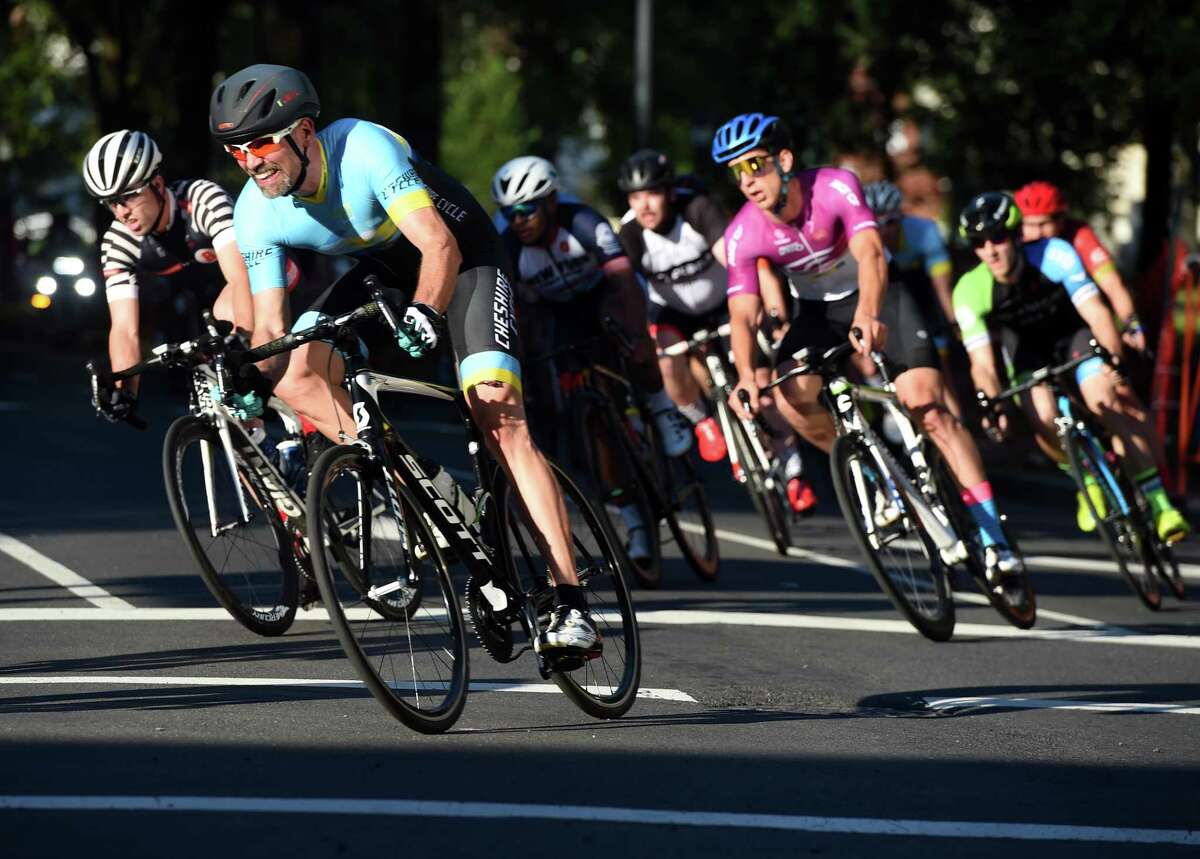 Riders turn the corner from Temple Street onto Chapel Street during the New Haven Grand Prix in downtown New Haven Friday. The twilight bicycle race and street festival will also take place today.