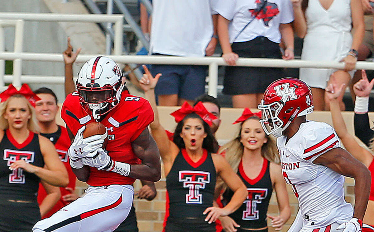 Texas Tech receiver TJ Vasher (9) hauls in a touchdown pass as a Houston defender gives chase. Photo by Wade H Clay