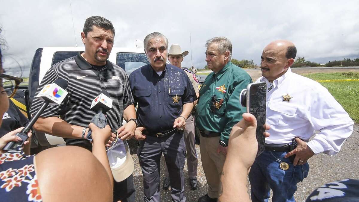 Webb County District Attorney Isidro Alaniz is joinged by Webb County Sheriff Martin Cuellar, Webb County Sheriff's Office's Federico Garza and Wayo Ruiz as Alaniz and Cuellar answer questions for the media at the location where a fourth body was found which is linked to a serial killer now in custody, Saturday, Sept. 15, 2018 near mile maker 14 on IH-35.