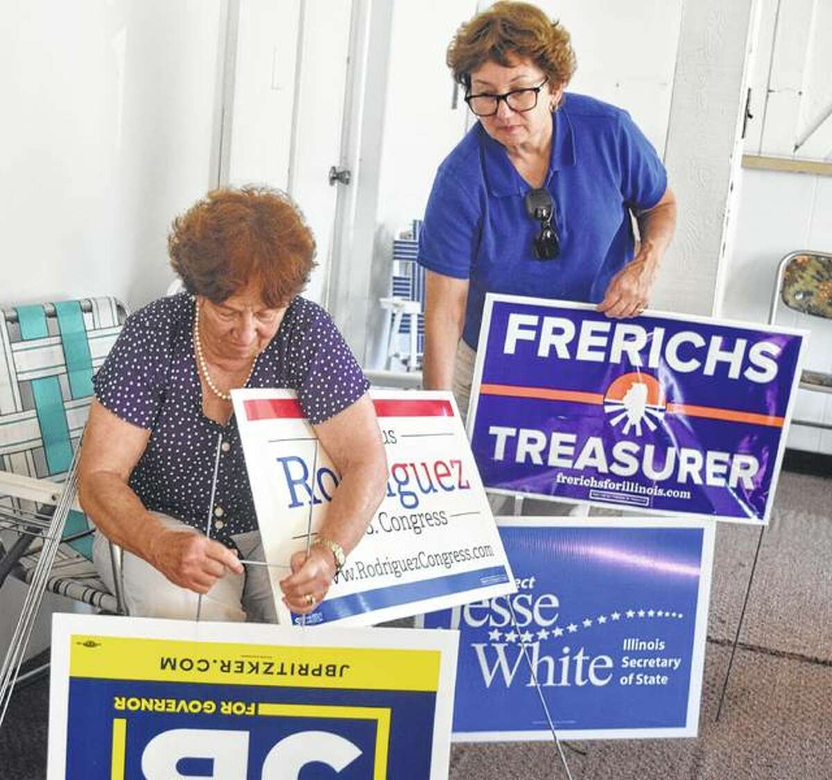 Judith Luchenbach Nelson (left), president of the Morgan County Democrats, and Dana Ryan, the Democratic central committee chair of Morgan County, put together signs Saturday during the open house at the Morgan County Democrats’ new headquarters. The organization will use the headquarters, located at 252 W. Morton Ave., until Nov. 6 and the office will be open on Tuesdays and Thursdays from 4:30 to 6:30 p.m. and on Saturdays from 10 a.m. to 2 p.m.