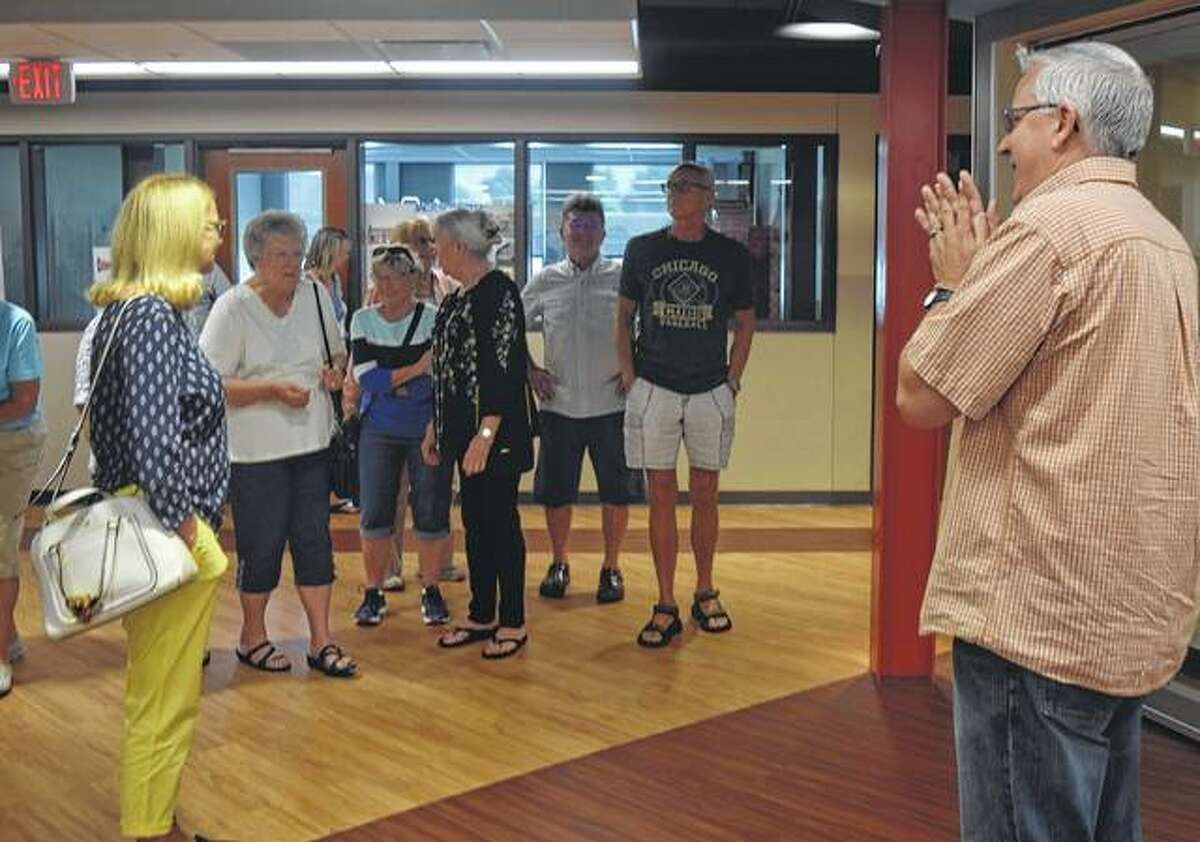 Jacksonville District 117 Superintendent Steve Ptacek (right) gives a tour of Jacksonville Middle School to the class of 1961 Saturday.