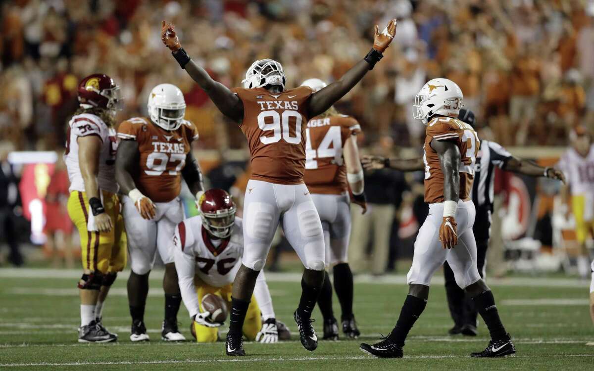 Texas defensive lineman Charles Omenihu (90) celebrates a stop against USC during the second half of an NCAA college football game, Saturday, Sept. 15, 2018, in Austin, Texas. Texas won 37-14. (AP Photo/Eric Gay)